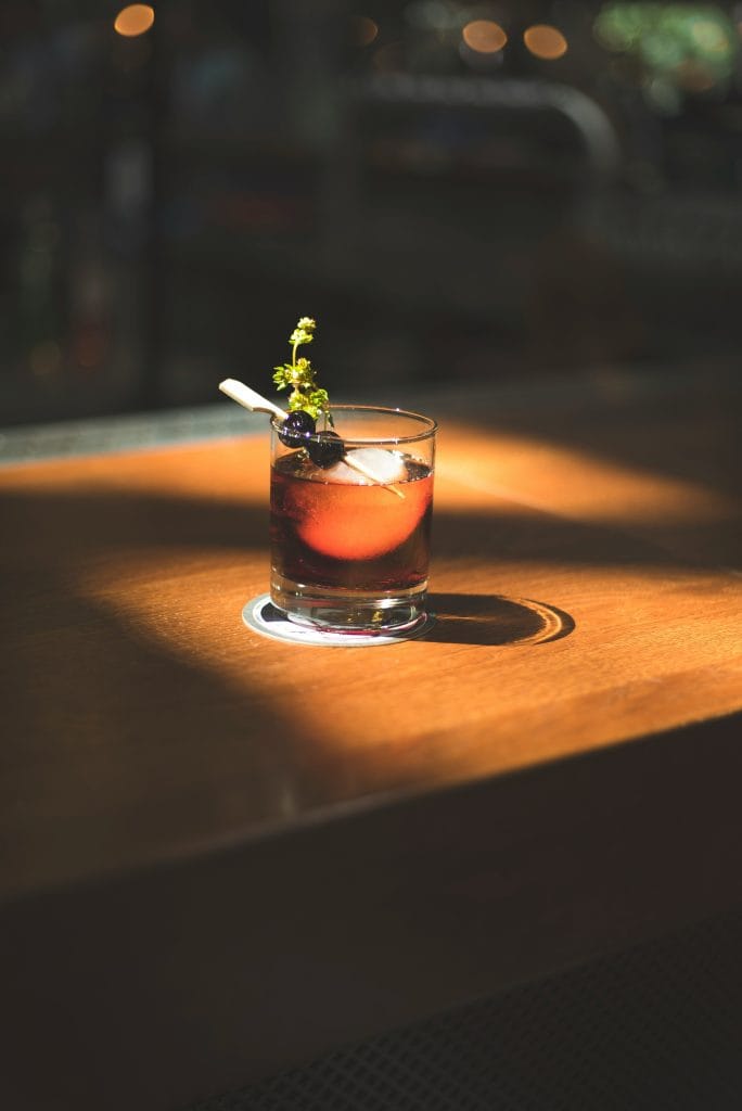 A cocktail in a table of copper city hotel and bar for about us page